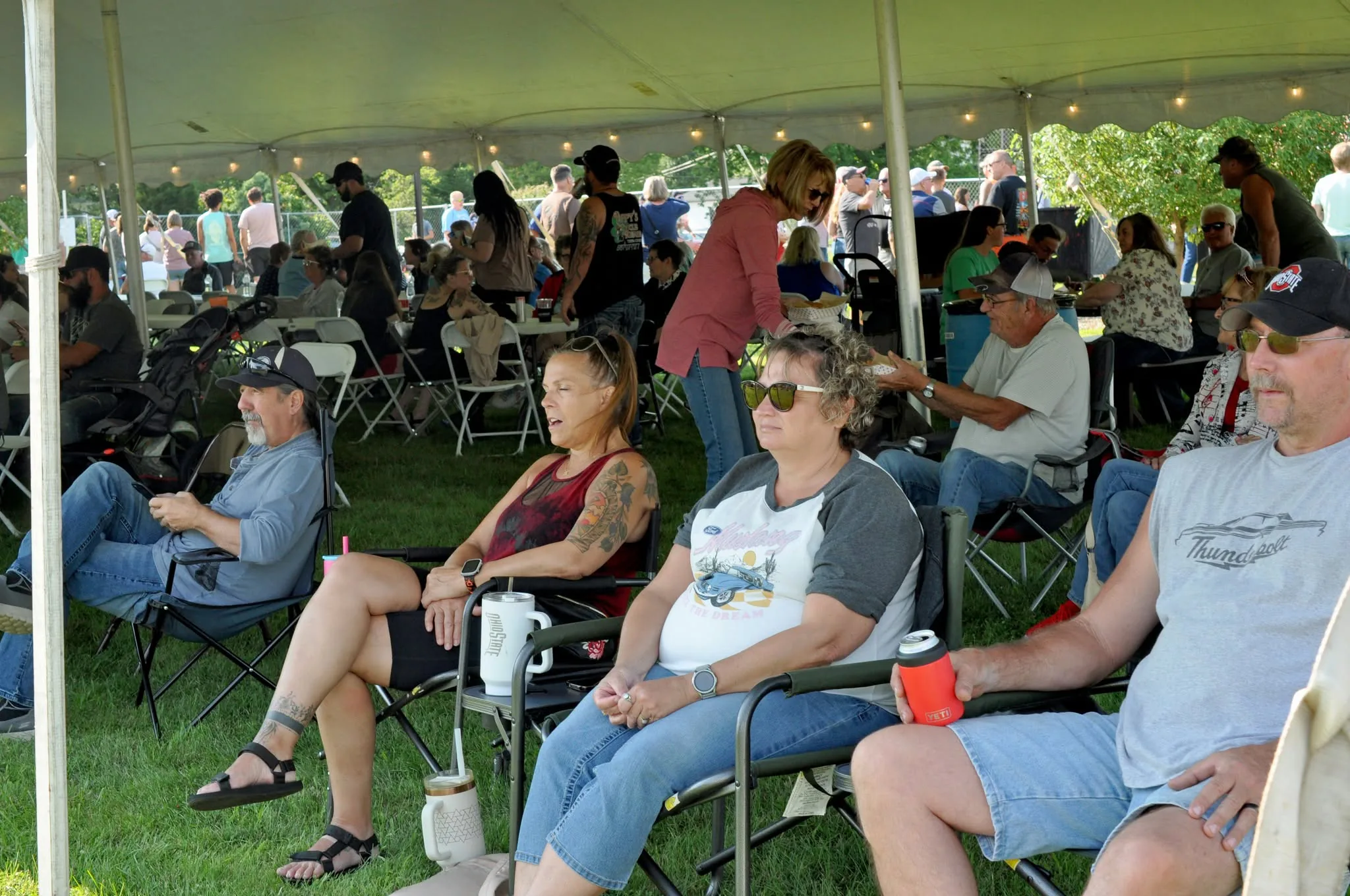 Friends and neighbors gathered beneath the community tent