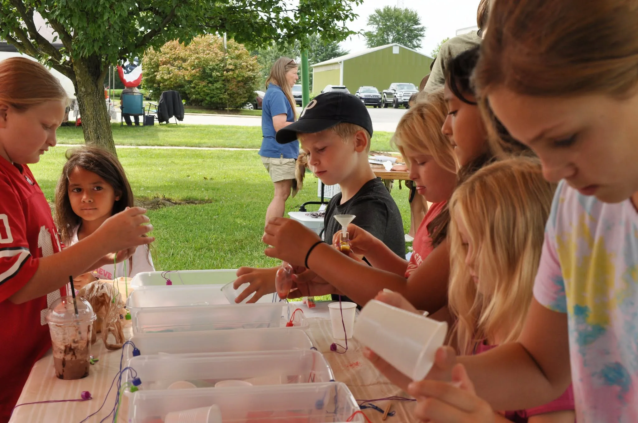 Children making colorful crafts together in the Kids Zone