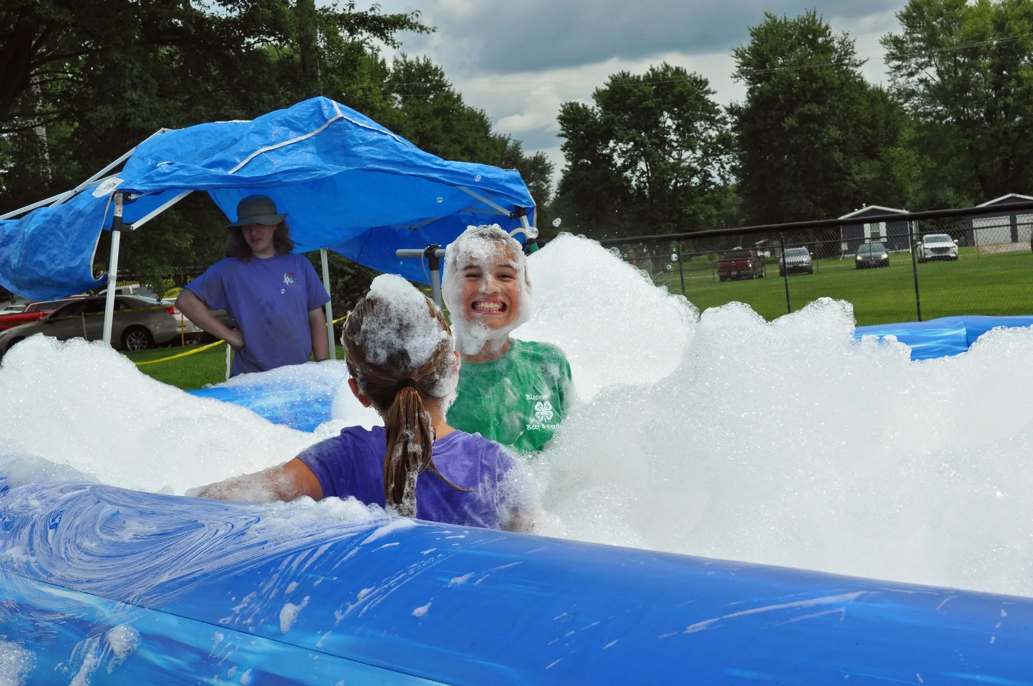 Children laughing in a mountain of foam