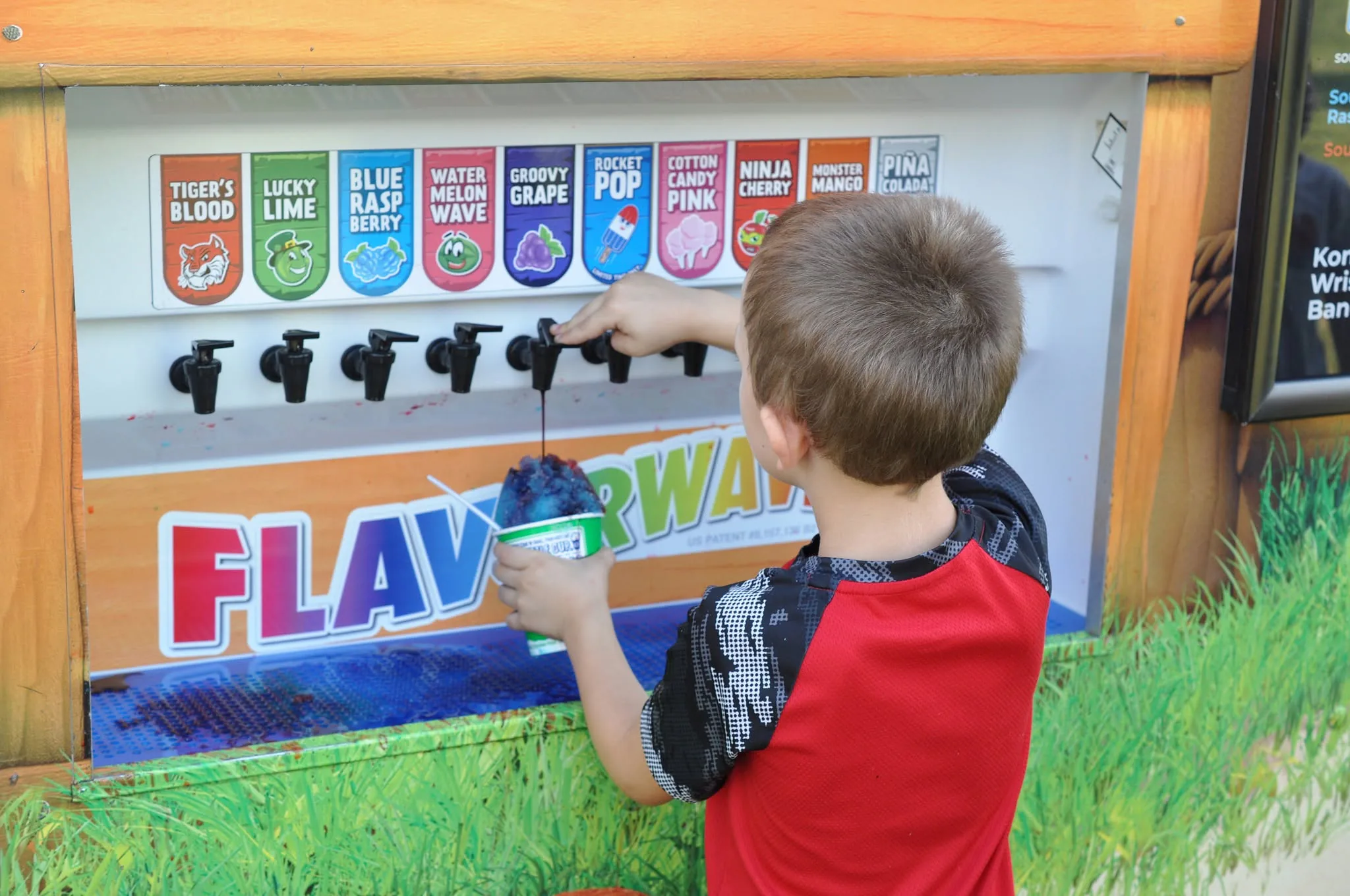 A child choosing a flavor for a shaved ice treat
