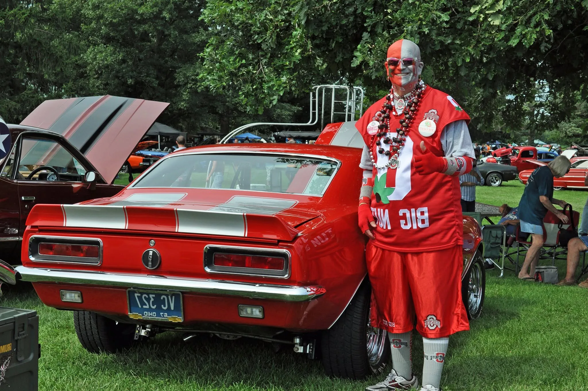 Ohio State superfan Big Nut beside a classic car